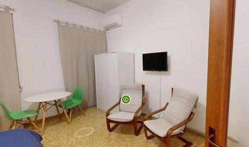 a room with chairs and a table and a tv at Apartment 50 m² in Cosenza with wifi and air conditioning in Cosenza
