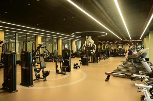 a gym with lots of treadmills and machines at Club Charholi in Lohogaon