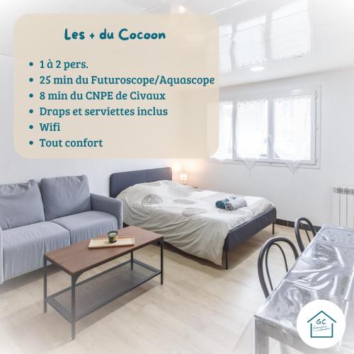 a living room with a bed and a couch at LE COCON - T1 - 26 m2 in Lhommaizé