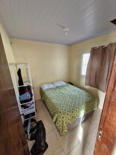 a bedroom with a bed and a cart in it at casa nova em imbé in Imbé