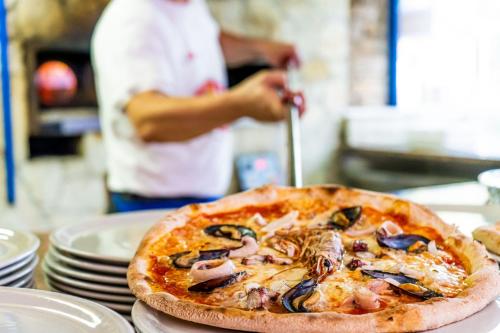 a pizza sitting on top of a table at Glamping at Sardinia in Alghero