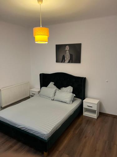 a bedroom with a bed with a black headboard at Central in inima orasului in Ploieşti