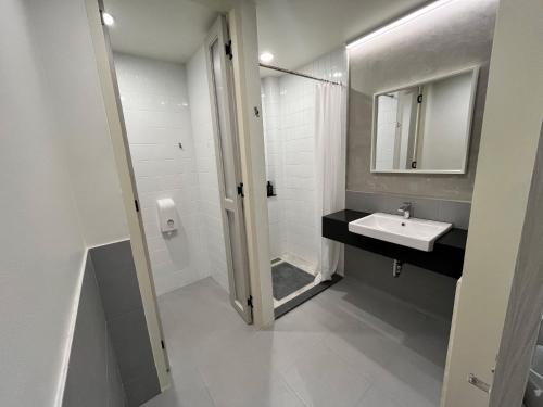 a white bathroom with a sink and a mirror at Hello my friend in Bang Bua Thong Railway Station