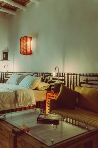 a living room with a bed and a couch at taman'art space in Aït Ben Haddou