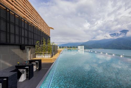 a swimming pool with a view of the mountains at Grand Hilai Sun Moon Lake in Yuchi