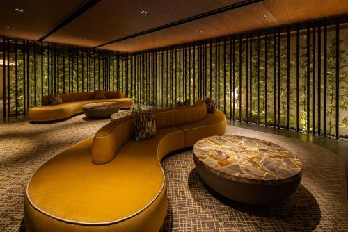 a lobby with a couch and a coffee table at Grand Hilai Sun Moon Lake in Yuchi