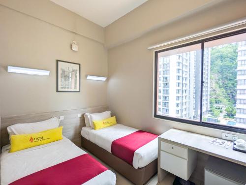 a room with two beds and a desk and a window at Le Quadri Kuala Lumpur By UCSI Hotels in Kuala Lumpur