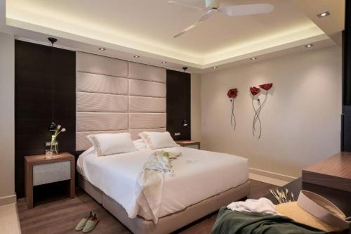 a bedroom with a bed with flowers on the wall at Cretan Dream Resort & Spa in Stalos