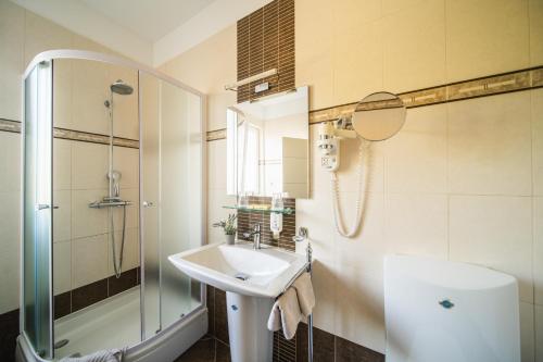 a bathroom with a sink and a shower at Pervanovo Apartments with Free Parking in Dubrovnik