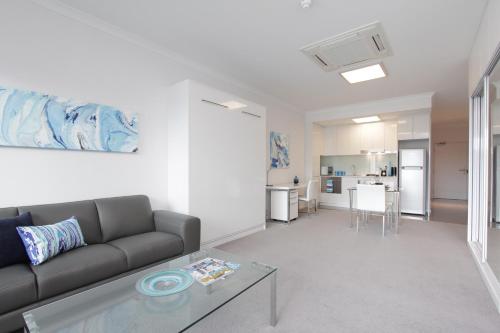 a living room with a couch and a table at 188 Apartments in Perth