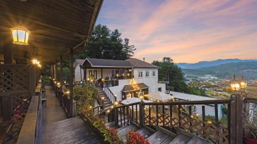 a house with a balcony with a view of the mountains at Gapyeong Bonita Pension in Gapyeong