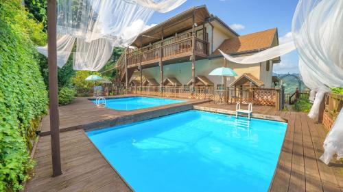 a villa with a swimming pool and a house at Gapyeong Bonita Pension in Gapyeong