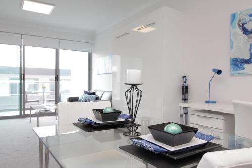 a living room with a glass table and a couch at 188 Apartments in Perth