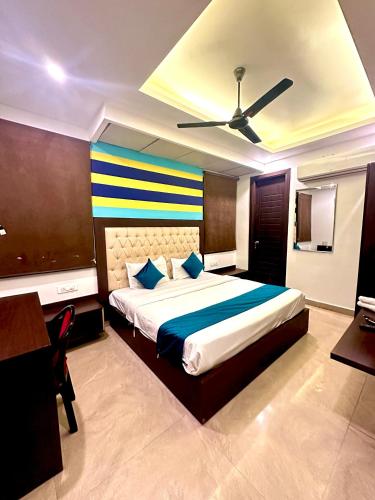a bedroom with a large bed with a ceiling at Hotel Surya Residency in Dehradun