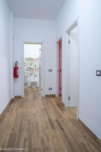 an empty hallway with white walls and wood floors at Sophie's Choice in Rome