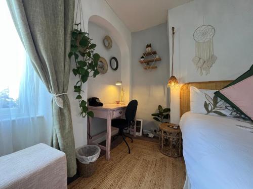 a bedroom with a desk and a bed and a table at The Sun in Wells
