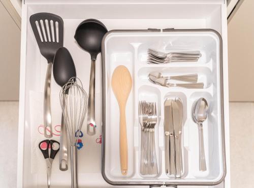 a drawer full of utensils in a white container at COMFY APARTMENT Wesseling in Wesseling