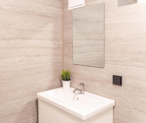 a bathroom with a white sink and a mirror at COMFY APARTMENT Wesseling in Wesseling