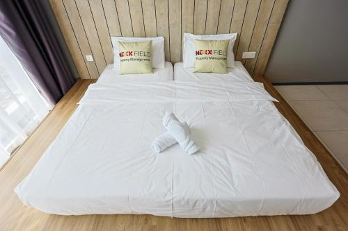 a large white bed with two pillows on it at Urban Suites Penang by Nexx Field in Jelutong
