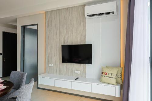 a living room with a tv on a wall at Urban Suites Penang by Nexx Field in Jelutong