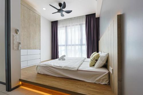 a bedroom with a bed with a ceiling fan at Urban Suites Penang by Nexx Field in Jelutong