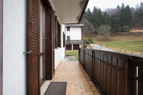 an open door of a house with a balcony at Appartamento Eva in Folgaria