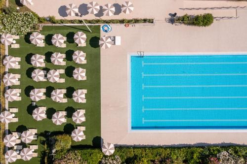 an overhead view of a swimming pool next to a beach at Club del Sole Vigna sul Mar Family Collection in Lido di Pomposa
