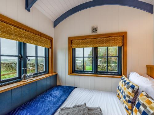 a bedroom with windows and a bed in it at The Dalesbred Hut - Uk40150 in Rathmell