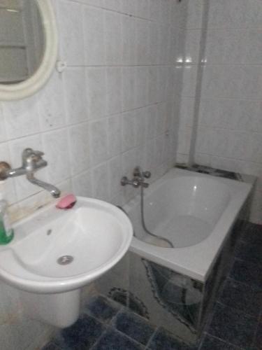 a bathroom with a sink and a toilet and a tub at كمب شيزار ادفو 35 in Alexandria