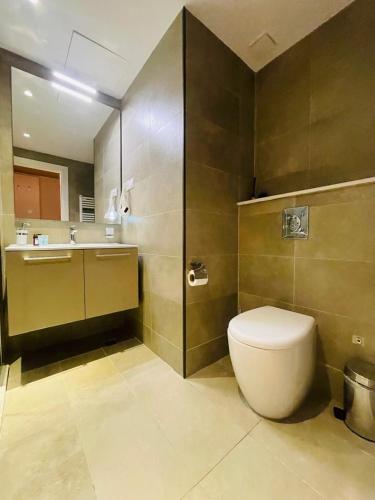 a bathroom with a toilet and a sink at Alliance palace 18 floor in Batumi