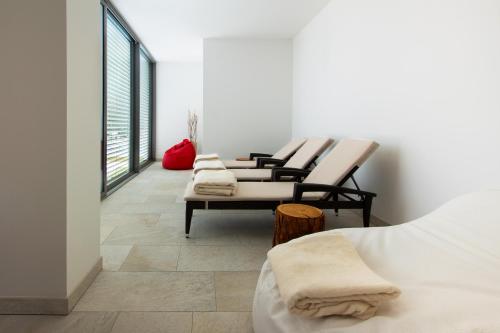 a row of chairs sitting in a room at Bellavista Relax Hotel in Levico Terme