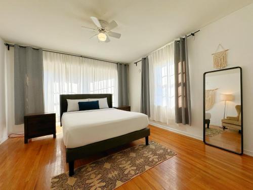 a bedroom with a large bed and a mirror at Bargain Beverly Hills 3 Bedroom in great area 5 minutes to Rodeo Drive in Los Angeles