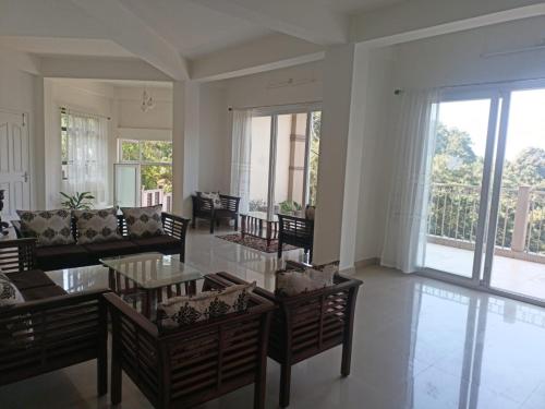 a living room with a couch and a table and chairs at Lashisha in Shillong