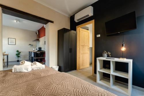 a bedroom with a large bed with a flat screen tv at Residence La Corte - Bilocale 4 in Novara