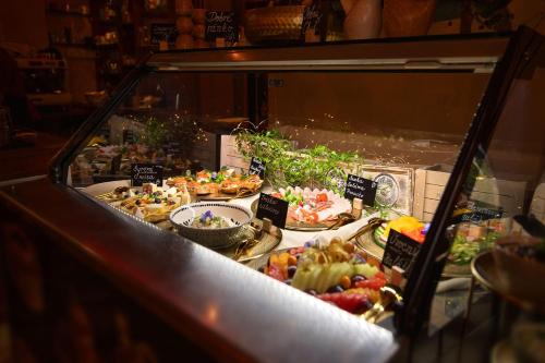 a display case with many different types of food at Hotel Kamélia in Žilina