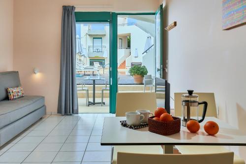 a living room with a couch and a table with oranges on it at Bella Vista Hotel "by Checkin" in Hersonissos
