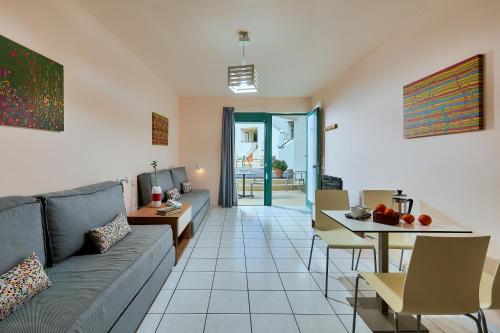 a living room with a couch and a table at Bella Vista Hotel "by Checkin" in Hersonissos