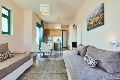 a living room with a couch and a table at Bella Vista Hotel "by Checkin" in Hersonissos
