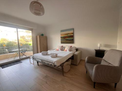 une chambre avec un lit, un canapé et une fenêtre dans l'établissement Confort porte de la Croisette, à Cannes