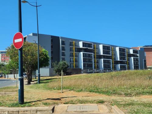 a street sign in front of a large building at Glorystar The Millennial Umhlanga in Durban