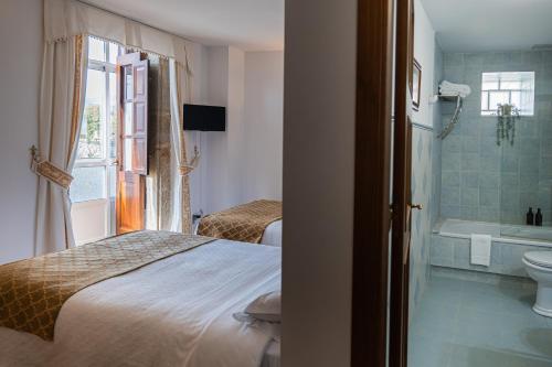 Postel nebo postele na pokoji v ubytování Hotel Rústico Fonteverde
