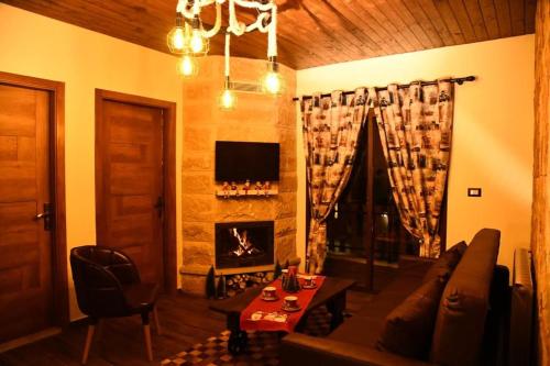 a living room with a couch and a fireplace at Rokwood faraya in Ash Sha‘rah