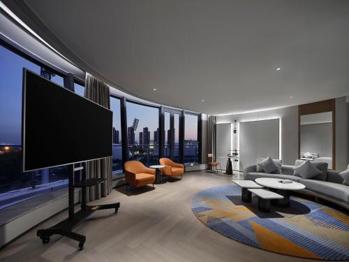 a living room with a flat screen tv in a building at EVEN Hotel Nanjing Yangtze River by IHG in Nanjing