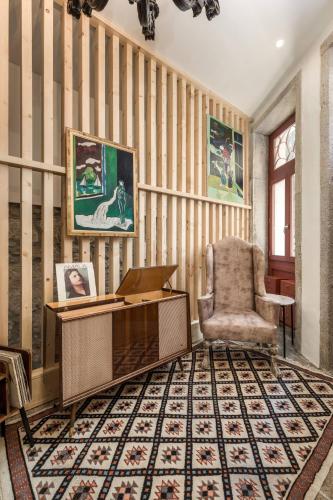 a desk and a chair in a room with striped walls at Beco do Paço by Porto Dream Stays in Porto