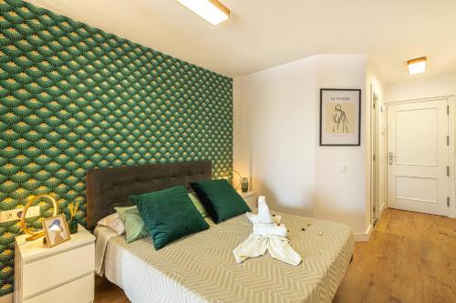 a bedroom with a bed with a green wall at Luxury Studio 1 ocean view wifi free in Adeje