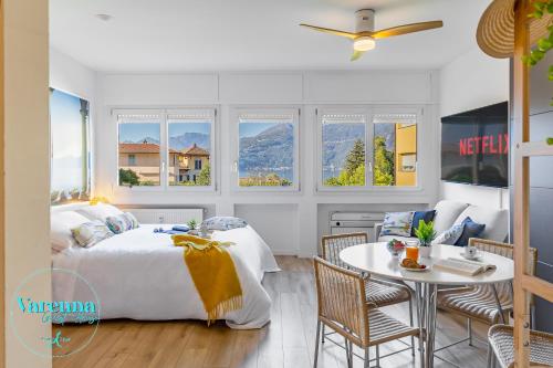 a bedroom with a bed and a table and chairs at VARENNA GUEST HOUSE 2 in Varenna