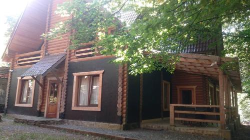 a small house with a porch on the side of it at Voronins Retreat House in Lumshory
