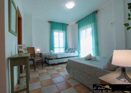a living room with a bed and a couch at Apartamento en el centro de Nerja by At Home Costa del Sol in Nerja
