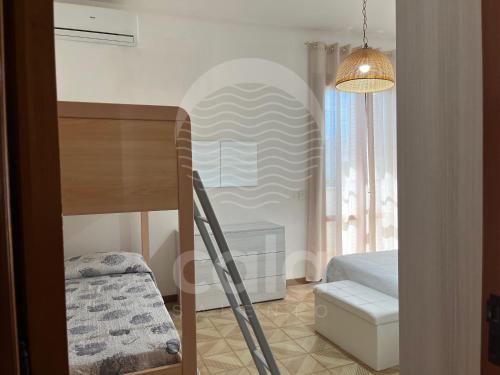 a room with a bed and a table and a window at Casa Estela By Cala Salento in Porto Cesareo