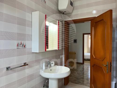 a bathroom with a sink and a mirror at Casa Estela By Cala Salento in Porto Cesareo